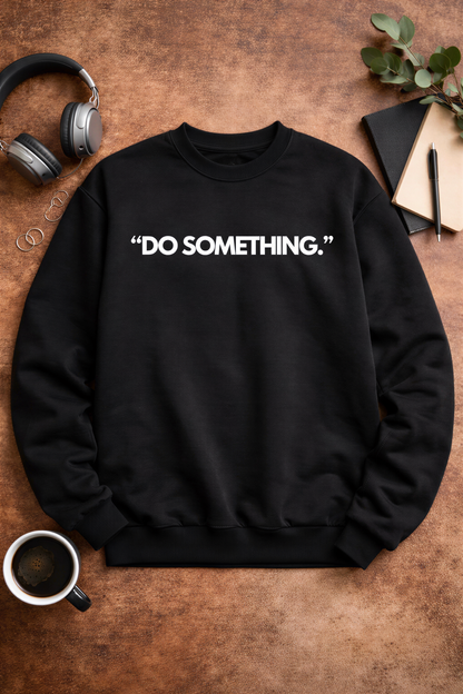 a black sweatshirt with the phrase "Do something" printed on it, along with a pair of headphones, a notebook, a pen, and a plant.